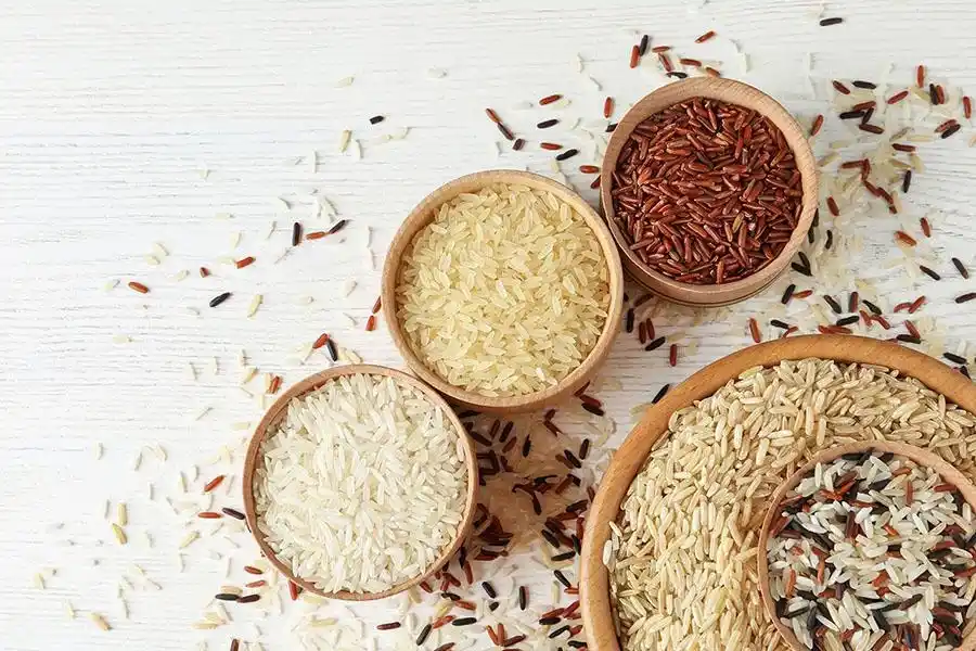 waqar rice mills vision, Biggest exporter of rice in pakistan, top rice exporter showing Flat lay composition with brown and other types of rice in bowls on white wooden background top notch no 1 exporter